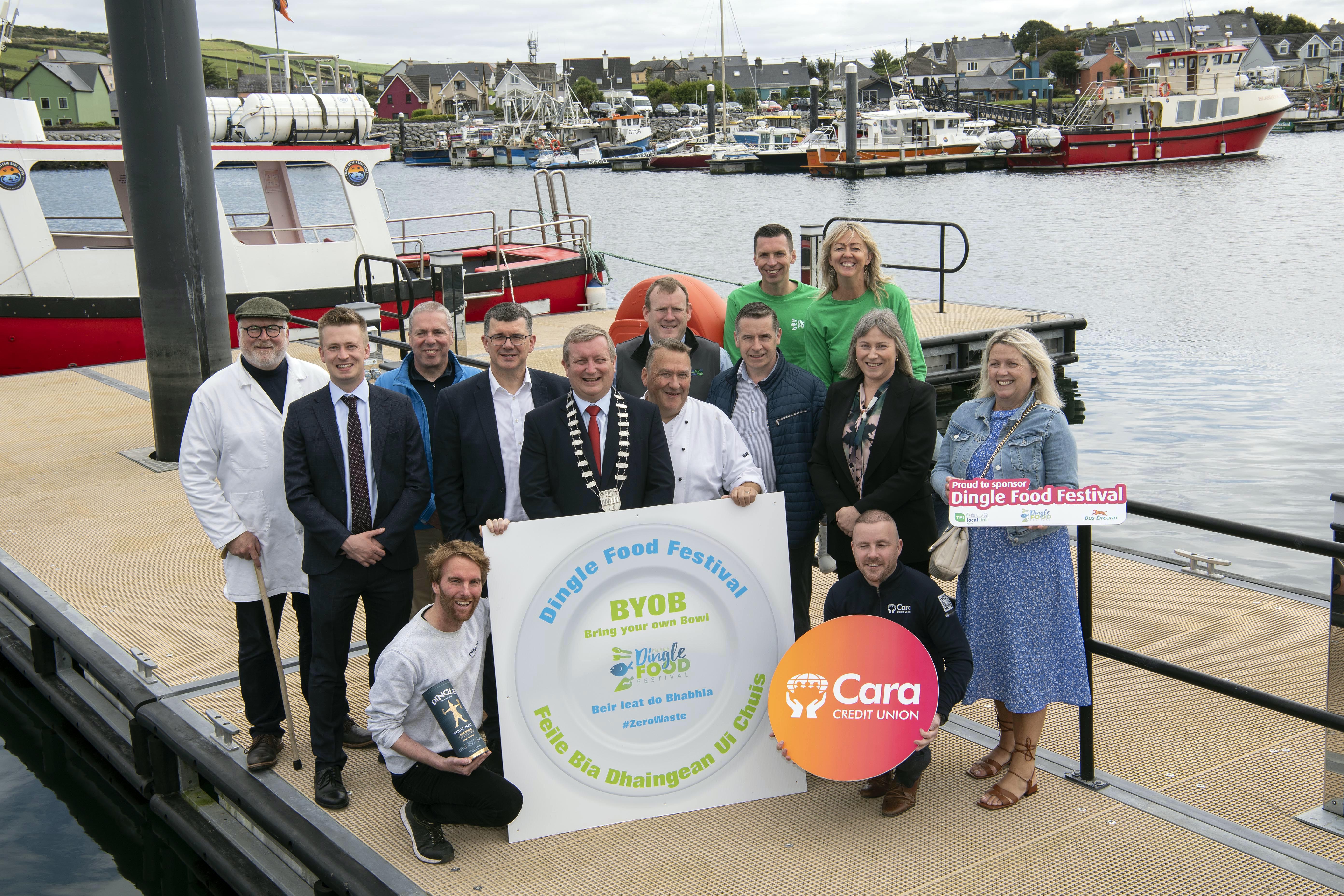 Bring your own bowl, rent a bowl or buy a bamboo bowl are the new changes to the 2024 Dingle Food Festival which is continuing its mission to be the first Irish “Zero Landfill Waste” festival and will take place from Friday 4th to Sunday the 6th of October in the West Kerry town.  Included are in photo are, Martin Bealin, Jamie Ó Flannura, Niamh O'Kennedy, from the festival committee with sponsors, front from left, Colm Giles, Dingle Whiskey and Philip Lynch, Cara Credit Union. At back, Trevis Gleason, Bia Dingle, Aled 
Williams, Bus Eireann, Declan Murphy, Failte Ireland, Jim Garvey, Garveys Supermarket, Mayor of Kerry Breandain MacGearailt, Alan O'Connell, TFI, Kevin o'Connor, Garveys Supermarket, Siun Dowd-O'Connor, Cara Credit Union and Fiona Connolly, Bus Eireann.
Taste trail and market outlets will only be serving food on to reusable tableware, with the main aim being to reduce the amount of disposable packaging over the weekend.
Photo: Don MacMonagle
PRESS RELEASE:
Dingle Food Festival, fantastic tastes, zero waste!
Once again this year, all festival goers are being encouraged to bring their own bowl - bear leat do babhla! For those who don’t, there will be stainless steel bowls available to rent for two euro (with five euro deposit). There will also be festival packs on sale consisting of a bamboo bowl and cutlery set. Taste trail and market outlets will only be serving food onto reusable tableware, with the main aim being to reduce the amount of disposable packaging over the weekend. Speaking at today’s launch, festival Chairperson Martin Bealin was highlighting the amount of waste festivals generate and the sustainable practices that the Dingle Food Festival are implementing to reduce this. “There will be approximately 150,000 tastings happening over the weekend, so getting rid of the disposable packaging will make a huge impact… it’s a big challenge for the Dingle Food Festival community but one we know will be embraced” he said.Other sustainable practices over the weekend will be  HVO Generators - festival generators will be run on ethically sourced HVO for the weekend, providing the electricity for the market stalls. Less Paper - printed material moving online, with a smaller festival programme being printed. 
Green Transport - working with Bus Éireann and The Local Link, providing more bus options to and from the peninsula over the weekend Sustainable practices workshops - workshops on how you can practice better sustainability including one specifically for children, delivered by Jennider Attard of MTU on “Limiting Food Waste” Micro Bio Digester manufacturer “MyGug” will set up  a micro bio digester to convert all the unavoidable food waste, instantly into gas, which will be used to power the cookery demonstrations by local producers. Highlights of this year’s festival include the much loved Taste Trail, where festival goers purchase a book of taste tickets and get to sample food delights throughout the picturesque town. Numerous Food Masterclasses and workshops will be taking place including Pitmaster Barbeqing from Smokin Soul, Seafood Curing and Smoking with Burren Smokehouse, Sourdough Making, Cake Baking and Wine Tasting and much much more. Tickets for all masterclass and workshops can be purchased from dinglefood.com where full the line up and event details are also listed. Together with the Blas na hEireann Irish Food Awards, market stalls, street entertainment, live music and kids activities, there really is something for everyone! Check out www.dinglefood.com
PHOTO ISSUED BY DINGLE FOOD FESTIVAL